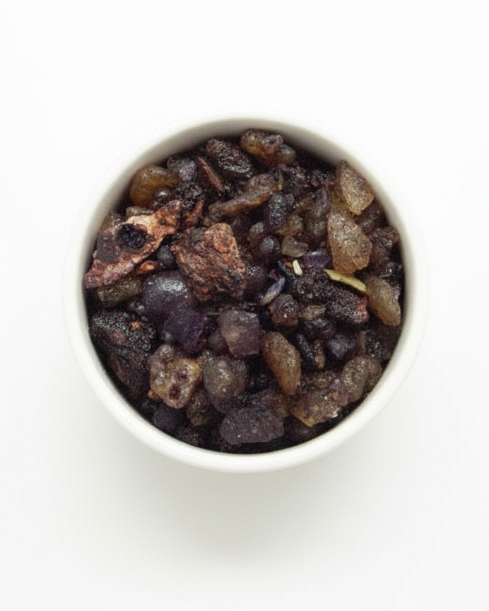 White bowl filled with resin incense on a white background