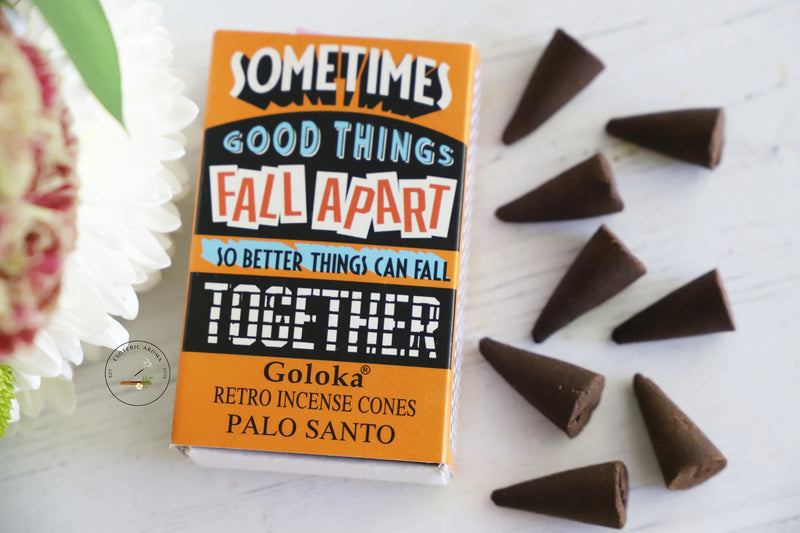 Sometimes Good Things Fall Apart so better things can fall Together incense cone box with 8 cones on a white background with fresh flowers on the side.