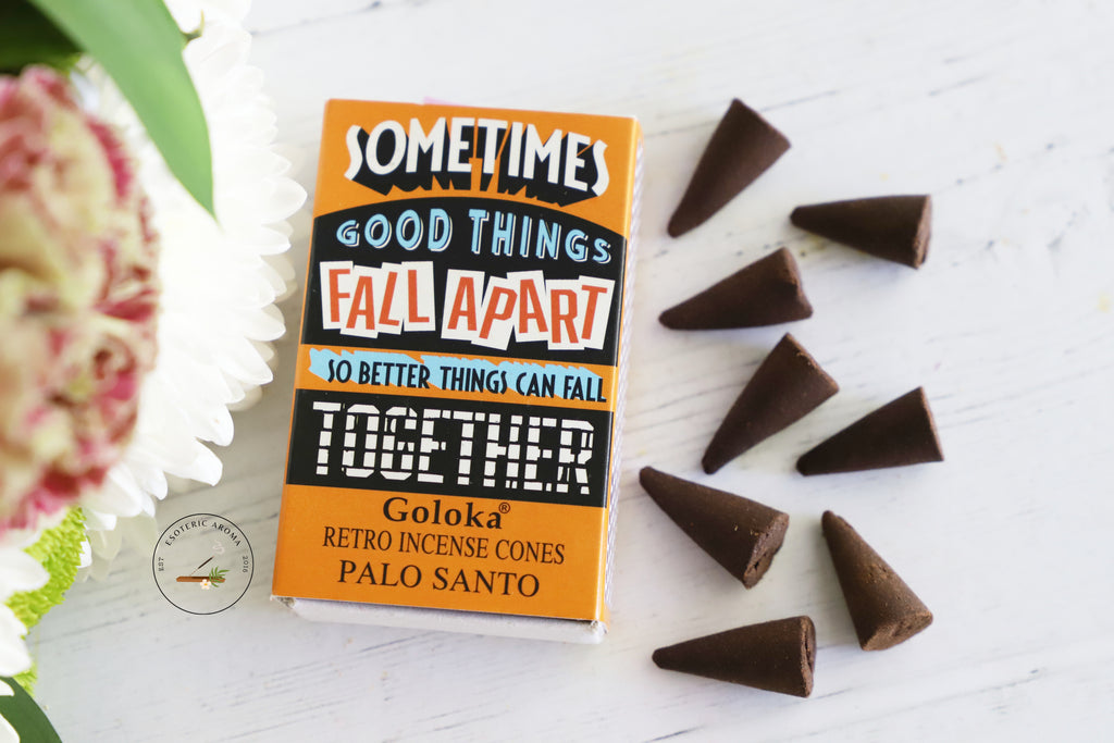 Sometimes Good Things Fall Apart so better things can fall Together incense cone box with 8 cones on a white background with fresh flowers on the side.