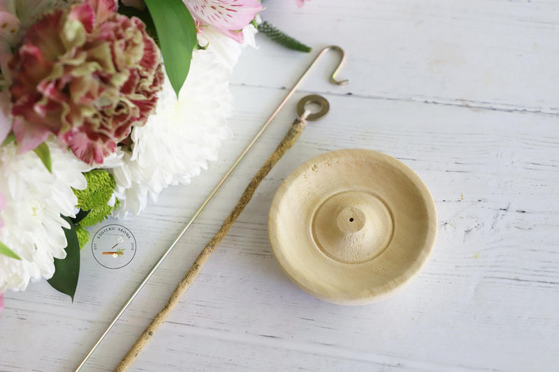 Round wooden incense rope holder, rope incense, metal rope holder on white background with fresh flowers.