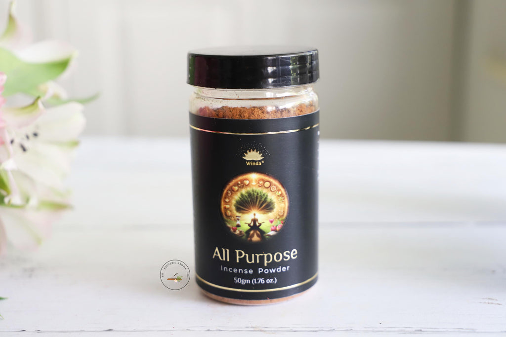 Vrinda All Purpose incense powder on a white table with a white background and white flowers on the side.