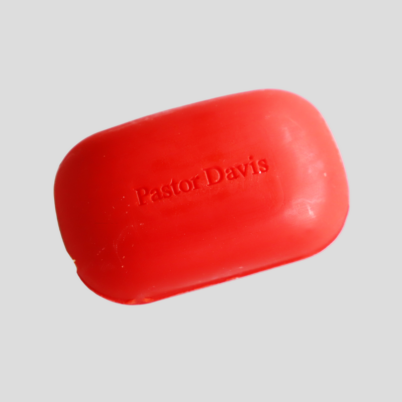 Red bar of soap with 'Pastor Davis' branding on a gray background