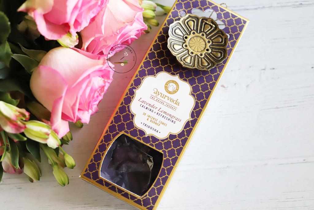 Ayurveda Lavender Lemongrass incense cones with burner package on a white background with pink and green flowers.