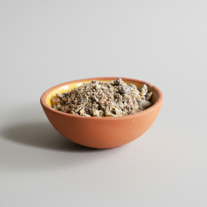 Resin incense in a bowl with orange, pink flowers on a white background