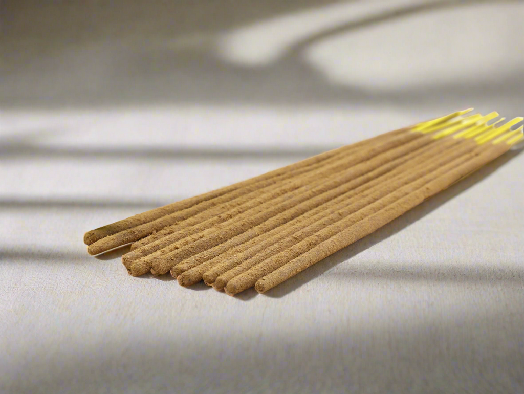 Incense sticks on a light fabric background