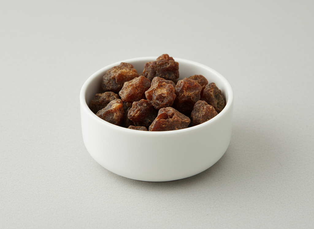 White bowl filled with resin incense on a light gray background