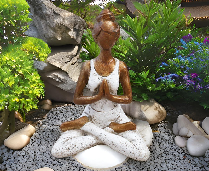 Yoga Lady statue in a zen garden