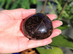 Polished Garnet palm stone